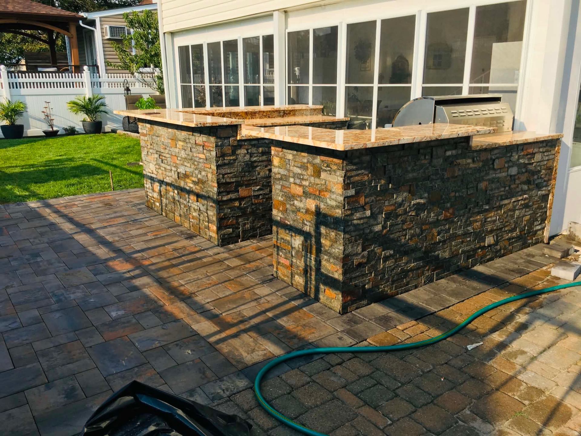 Outdoor stone kitchen with paver patio
