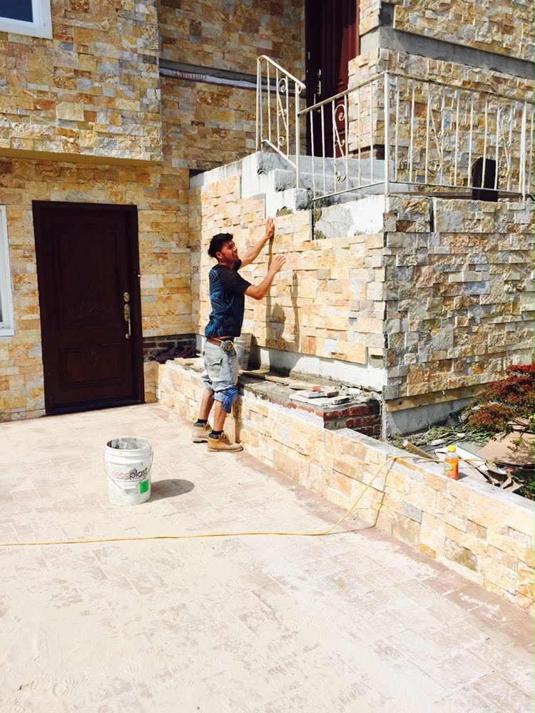 Mason installing stacked stone veneer