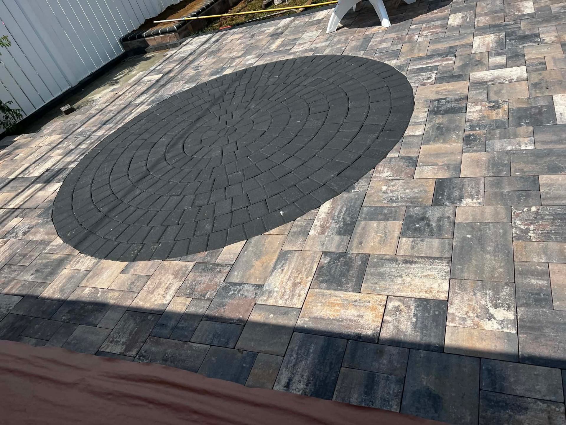 Paver patio with charcoal circle inlay